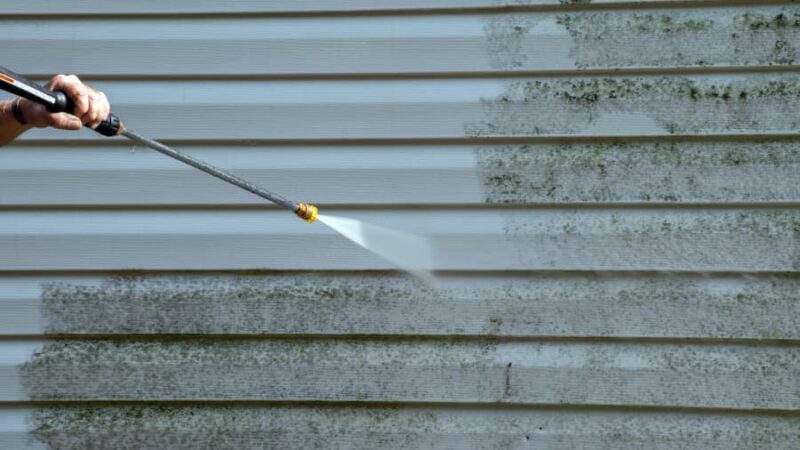 power washing dirty siding with high pressure water