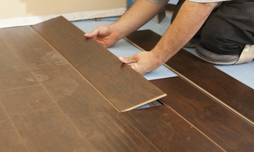 Man Installing New Laminate Wood Flooring